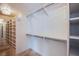 Bright white walk-in closet with shelves and hanging rods at 222 Karen Ave # 2308, Las Vegas, NV 89109