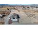 A high-angle view showcases the new house with desert landscaping with city and mountain views at 2560 Tahachapi Ave, Pahrump, NV 89048