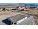 An aerial view of a house featuring a tile roof, large lot, and views of distant mountains at 2560 Tahachapi Ave, Pahrump, NV 89048