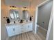 Modern bathroom featuring a double vanity and stylish light fixtures at 2560 Tahachapi Ave, Pahrump, NV 89048