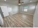 Spacious bedroom featuring a ceiling fan, window, and door leading to another room at 2560 Tahachapi Ave, Pahrump, NV 89048