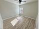 Bright bedroom featuring a ceiling fan, large window, and light-colored walls and flooring for a modern aesthetic at 2560 Tahachapi Ave, Pahrump, NV 89048