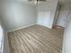 Neutral bedroom featuring light walls, wood-look flooring, a closet, and a window for natural light at 2560 Tahachapi Ave, Pahrump, NV 89048
