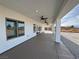 Side view of a covered patio with ceiling fans and windows, offering backyard views at 2560 Tahachapi Ave, Pahrump, NV 89048