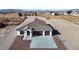 Stunning new construction home featuring a spacious driveway and desert landscaping at 2560 Tahachapi Ave, Pahrump, NV 89048