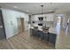 Bright kitchen with island, modern lighting, white cabinets, breakfast bar, and stainless appliances at 2560 Tahachapi Ave, Pahrump, NV 89048
