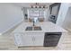 Kitchen island with white cabinets, quartz countertop & sink at 2560 Tahachapi Ave, Pahrump, NV 89048