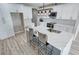 Modern kitchen boasts white cabinetry, stylish backsplash, quartz counters, and updated stainless appliances at 2560 Tahachapi Ave, Pahrump, NV 89048