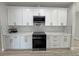 Elegant kitchen featuring stainless steel appliances, white cabinetry, and stone countertops at 2560 Tahachapi Ave, Pahrump, NV 89048