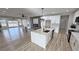 Open-concept kitchen features a large island, sleek countertops, and modern stainless steel appliances at 2560 Tahachapi Ave, Pahrump, NV 89048