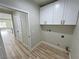 Laundry room with white cabinets and vinyl flooring at 2560 Tahachapi Ave, Pahrump, NV 89048