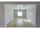 Inviting living room with wood-look floors and modern lighting, creating a warm and stylish atmosphere at 2560 Tahachapi Ave, Pahrump, NV 89048
