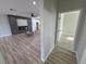 Open-concept living room with fireplace, tile accent wall, and modern flooring; seamlessly connects to other living spaces at 2560 Tahachapi Ave, Pahrump, NV 89048
