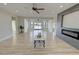 Open concept living room features modern fireplace, ceiling fan, and plenty of natural light at 2560 Tahachapi Ave, Pahrump, NV 89048