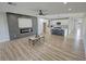 Open concept living room with modern fireplace, kitchen, and access to outdoor space at 2560 Tahachapi Ave, Pahrump, NV 89048