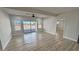 Bright living area with sliding glass doors, ceiling fan, and modern flooring at 2560 Tahachapi Ave, Pahrump, NV 89048