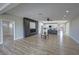 Open concept living room with fireplace and view into modern kitchen at 2560 Tahachapi Ave, Pahrump, NV 89048