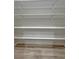 Walk-in pantry featuring adjustable shelving and modern flooring at 2560 Tahachapi Ave, Pahrump, NV 89048