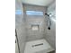 Modern tiled shower with a built-in niche, rain shower head, and sleek design, enhancing bathroom appeal at 2560 Tahachapi Ave, Pahrump, NV 89048