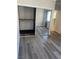 Bright bedroom featuring new gray wood flooring and mirrored closet doors at 260 E Flamingo Rd # 433, Las Vegas, NV 89169