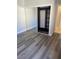 Comfortable bedroom showcasing new gray wood flooring and mirrored closet doors at 260 E Flamingo Rd # 433, Las Vegas, NV 89169