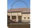 View of a multi-story building with a red tile roof and the High Roller wheel in the background at 260 E Flamingo Rd # 433, Las Vegas, NV 89169