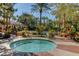 Relaxing pool area with hot tub, lounge chairs, and palm trees at 260 E Flamingo Rd # 433, Las Vegas, NV 89169