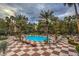 Well landscaped pool area with palm trees and lounge seating for residents at 260 E Flamingo Rd # 433, Las Vegas, NV 89169