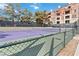 Purple tennis court with net and surrounding fence at 260 E Flamingo Rd # 433, Las Vegas, NV 89169