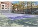 Purple tennis court with net and surrounding fence at 260 E Flamingo Rd # 433, Las Vegas, NV 89169