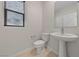 Small bathroom with pedestal sink and window at 2720 High Echelon Rd, North Las Vegas, NV 89086