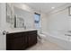 Bathroom with tub, shower, and dark vanity at 2720 High Echelon Rd, North Las Vegas, NV 89086