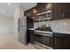 Stainless steel appliances and dark brown cabinets in this kitchen at 2720 High Echelon Rd, North Las Vegas, NV 89086