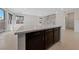 Kitchen island with dark brown cabinets and quartz countertop at 2720 High Echelon Rd, North Las Vegas, NV 89086