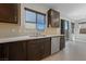 Kitchen with dark cabinets, stainless steel appliances, and tile backsplash at 2720 High Echelon Rd, North Las Vegas, NV 89086