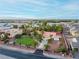 Aerial view of single-story house with large yard, palm trees, and distant mountain views at 274 Doobie Ave, Las Vegas, NV 89183