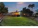 Backyard patio with pergola, seating area, and lawn at dusk at 274 Doobie Ave, Las Vegas, NV 89183