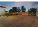 Large gravel backyard with a gated entrance and a rock wall at 274 Doobie Ave, Las Vegas, NV 89183