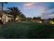 Landscaped backyard with lush lawn at dusk at 274 Doobie Ave, Las Vegas, NV 89183