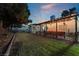 Backyard with covered patio and lawn at dusk at 274 Doobie Ave, Las Vegas, NV 89183