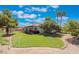 Large grassy backyard with mature trees and a covered patio at 274 Doobie Ave, Las Vegas, NV 89183