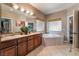 Bathroom with corner bathtub and double vanity at 274 Doobie Ave, Las Vegas, NV 89183