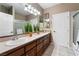 Bathroom boasts double sinks, wood cabinets, and a shower at 274 Doobie Ave, Las Vegas, NV 89183