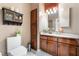 Small bathroom with wooden cabinetry and toilet at 274 Doobie Ave, Las Vegas, NV 89183