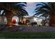 Elegant home entrance with red doors, fountain, and palm trees at dusk at 274 Doobie Ave, Las Vegas, NV 89183