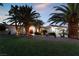 House exterior view at dusk showcasing a red door and palm trees at 274 Doobie Ave, Las Vegas, NV 89183