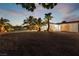 Night view of house exterior showcasing the landscaping and a gravel driveway at 274 Doobie Ave, Las Vegas, NV 89183