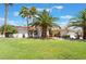 Single-story home with palm trees and a lush green lawn at 274 Doobie Ave, Las Vegas, NV 89183