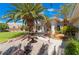 Landscaped front yard with palm trees, fountain, and stone pathway at 274 Doobie Ave, Las Vegas, NV 89183