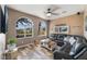 Living room with sectional sofa and wood-look tile floor at 274 Doobie Ave, Las Vegas, NV 89183